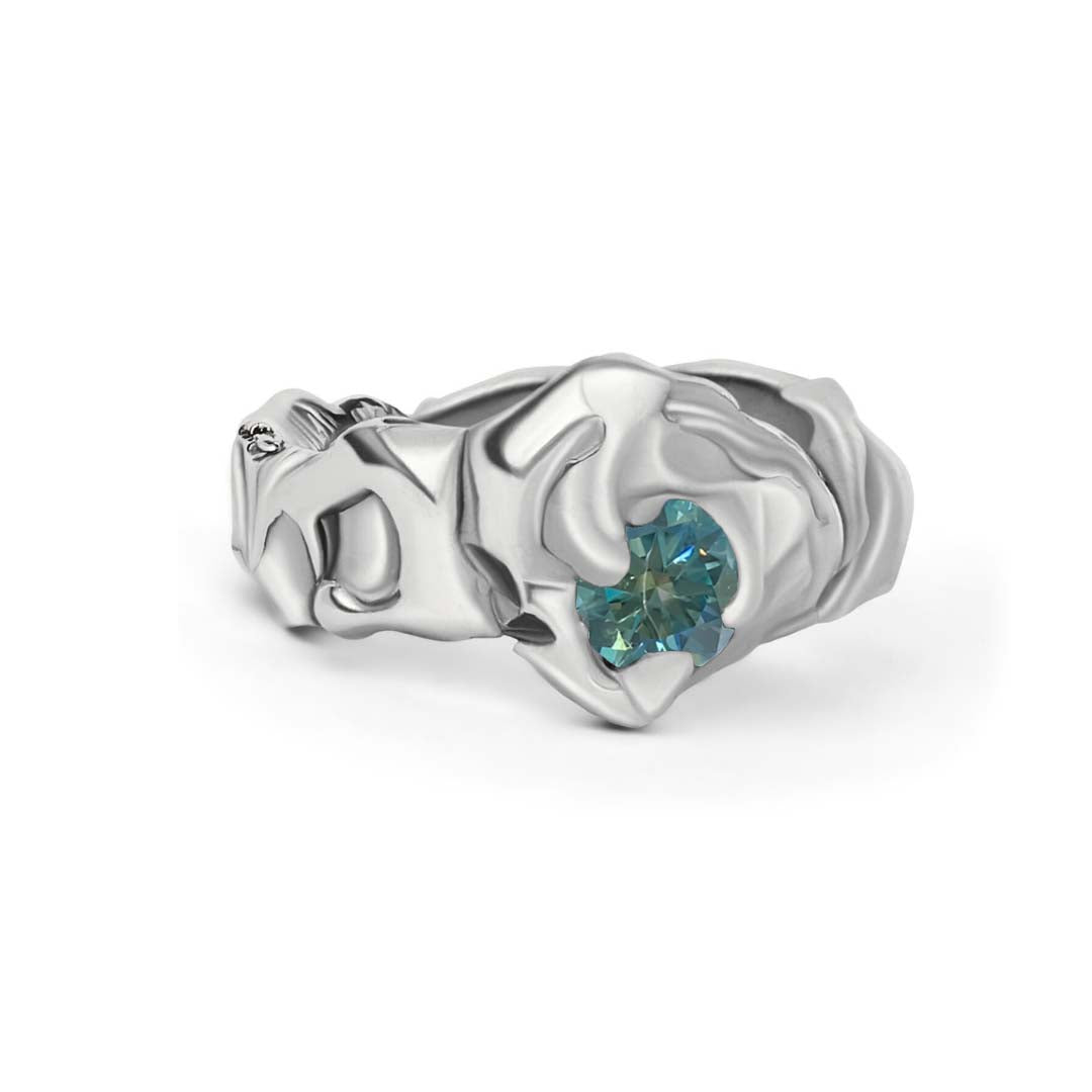 The Ember Ring by Madeleine Sculptural Jewellery is a hand-carved silver piece featuring an abstract design with a central round moissanite gemstone.