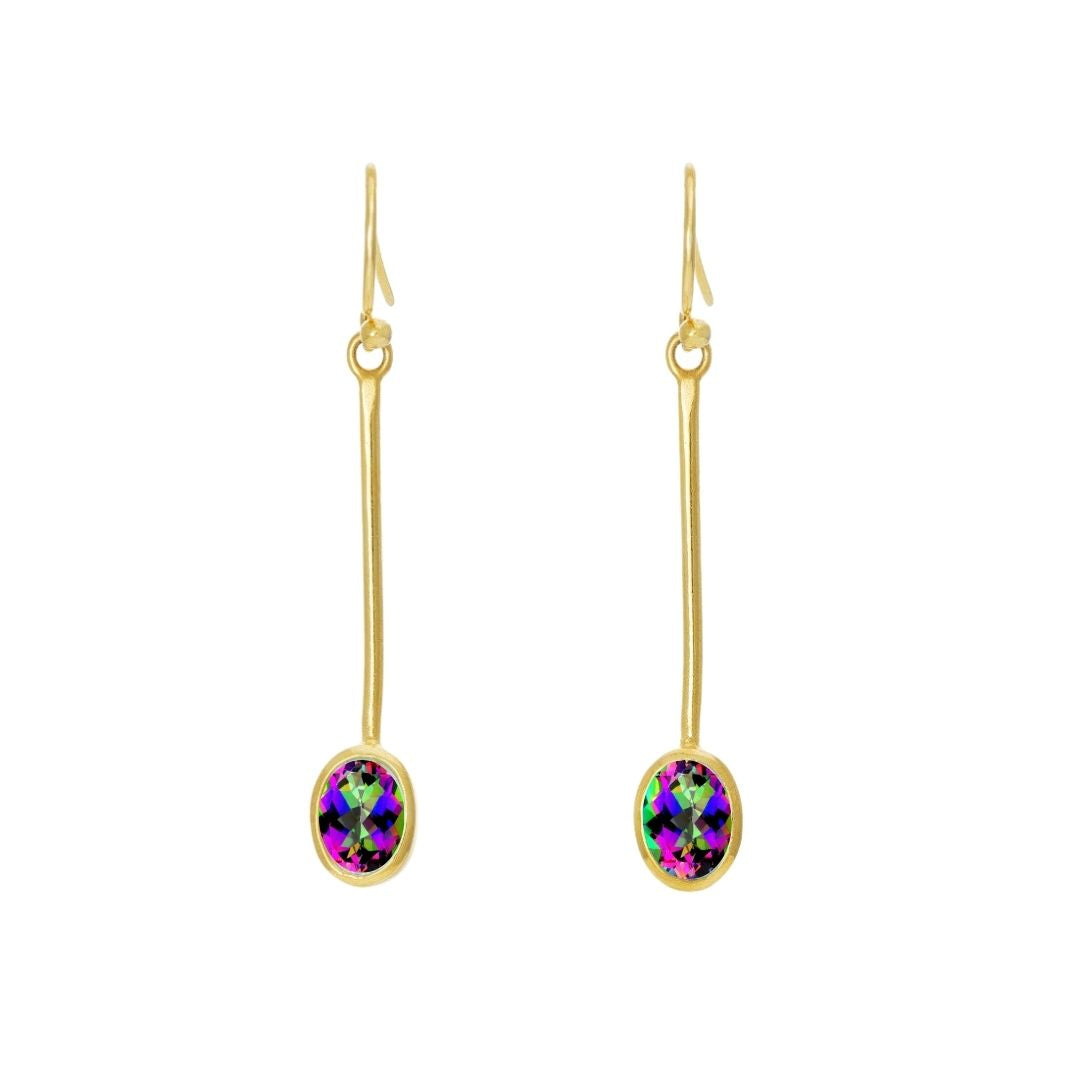 Gallardo & Blaine Designs' Sequola Earrings feature gold drop earrings with long, thin hooks and iridescent oval gemstones displaying vibrant green, purple, and blue hues. These earrings add a colorful accent to their sleek design, offering timeless charm