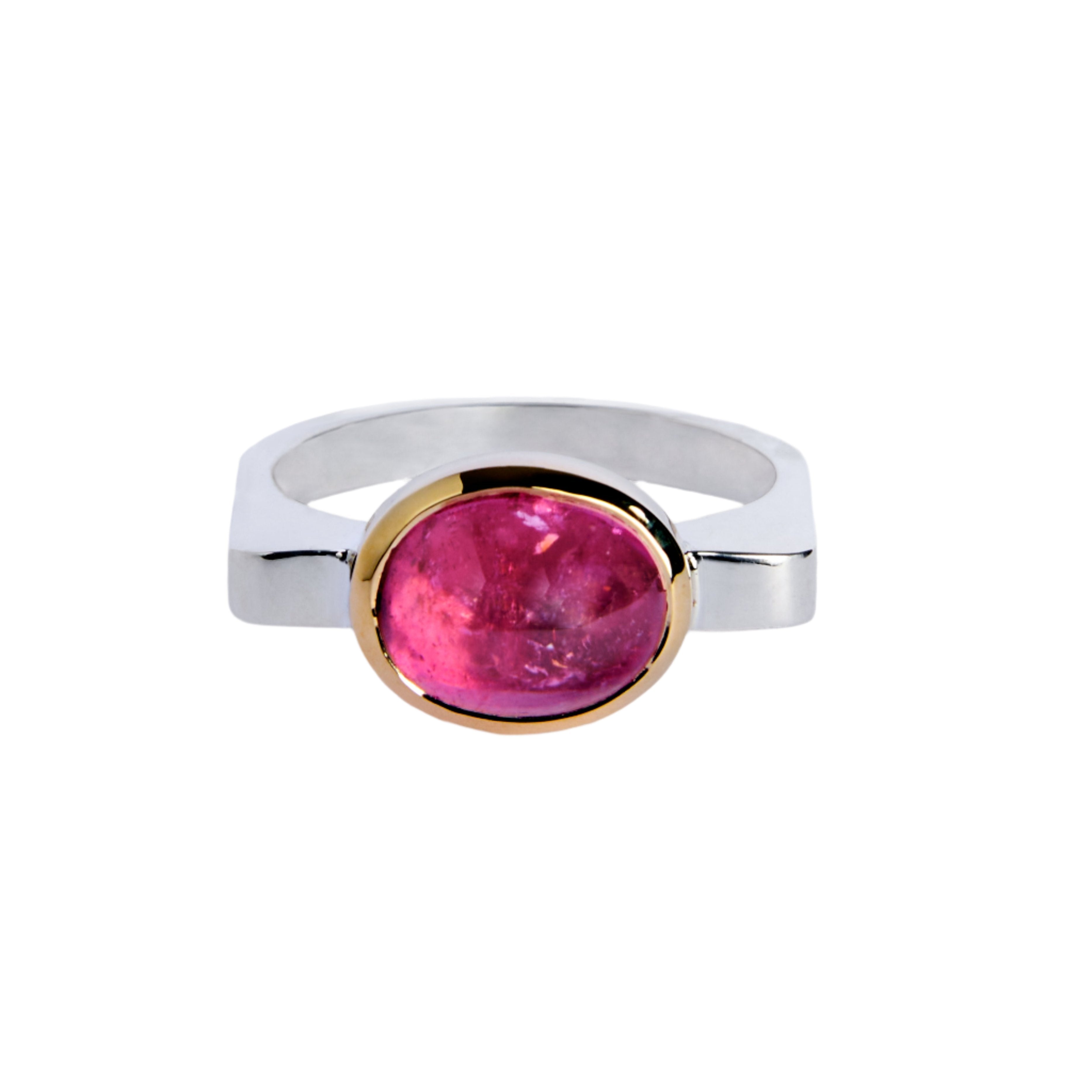 The Stellar Blush Silver & Gold Ring by Madeleine Fine Jewellery features a large oval cabochon pink tourmaline in a gold bezel, elegantly displayed against a white background.