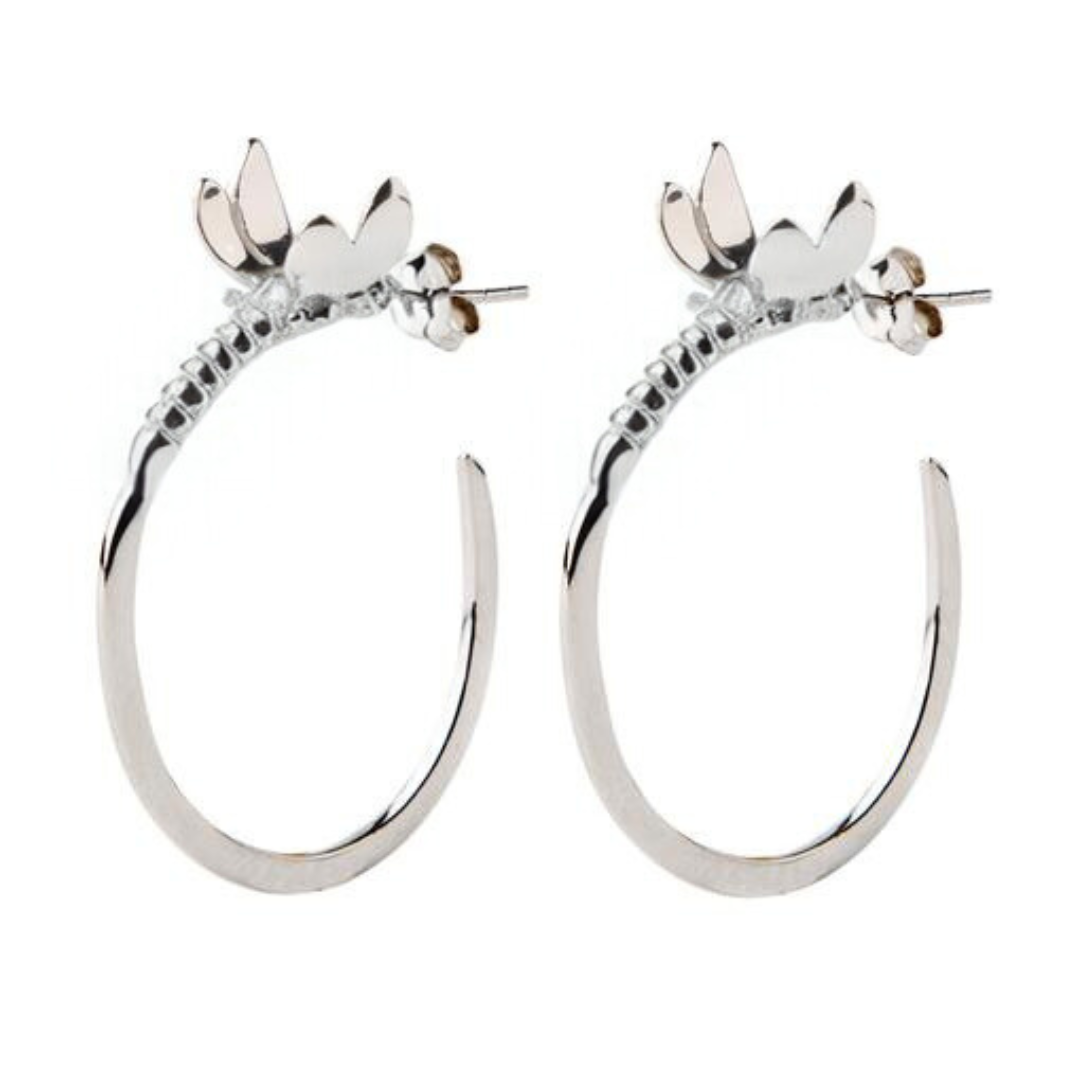 The Wildlife Dragonfly Hoop Earrings by Watermelon Tropical feature nature-inspired dragonflies with detailed wings and bodies extending into silver or gold hoops for an elegant touch.