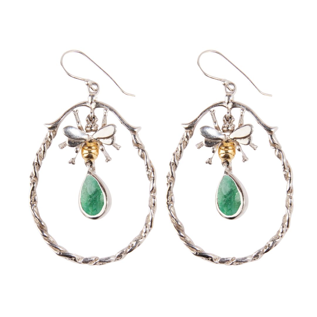 The Wildlife Large Bee Hoop Drops by Watermelon Tropical feature silver hoops, gold-detailed bees at the top, and green teardrop gemstones hanging below each bee.