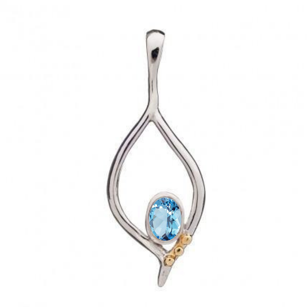 The Desert Flame Pendant by Gallardo & Blaine Designs is a silver teardrop with art nouveau flair, featuring a blue oval gemstone and three small gold embellishments on one side.