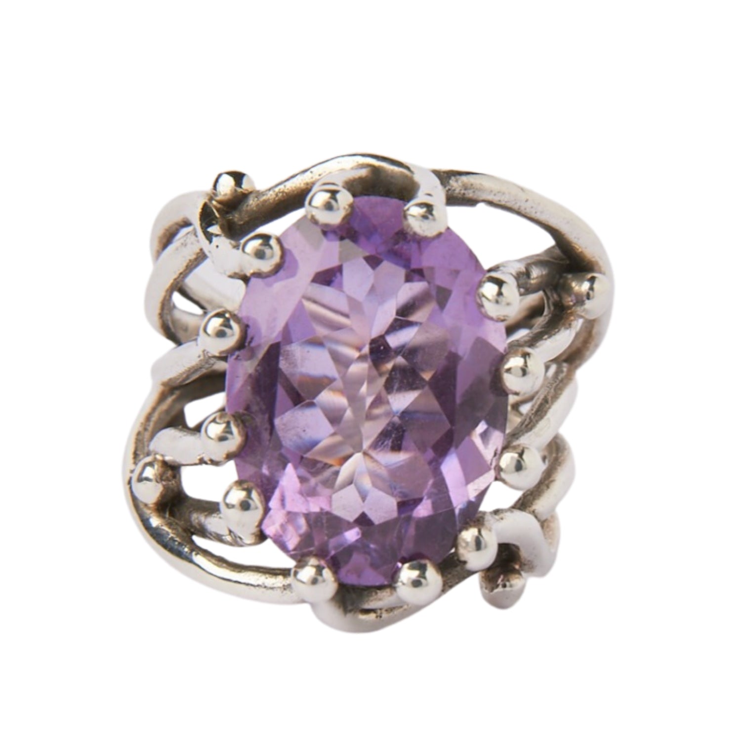 The Willow Ring by Gallardo & Blaine Designs features an intricate, wavy sterling silver band and a striking oval-cut purple gemstone at its center.