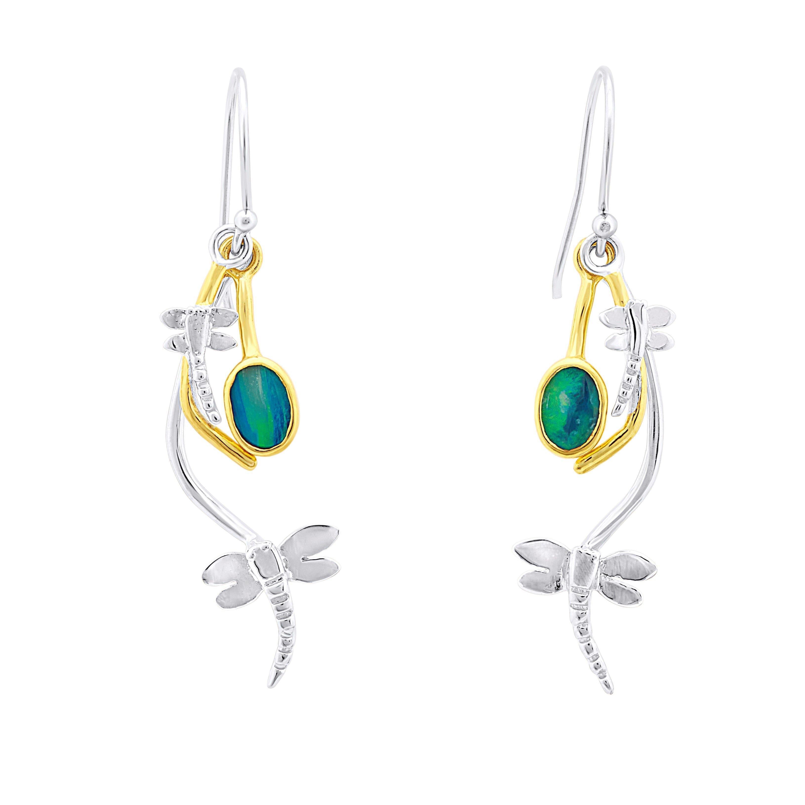 A pair of Ripple Earrings in various gemstones by Gallardo & Blaine Designs featuring a dragonfly design. Each earring has a small, oval-shaped green gemstone set in a gold accent, with a dragonfly figure extending below. They have hook-style clasps for w