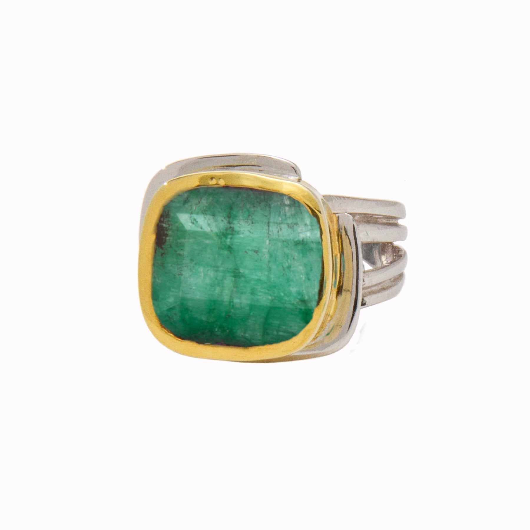 A square-cut green gemstone, possibly an emerald, is set in a sterling silver band ring with a gold vermeil bezel. The Art Deco Ring in Silver Gold & various gemstones by Gallardo & Blaine Designs features a broad, slightly curved design with multiple ban