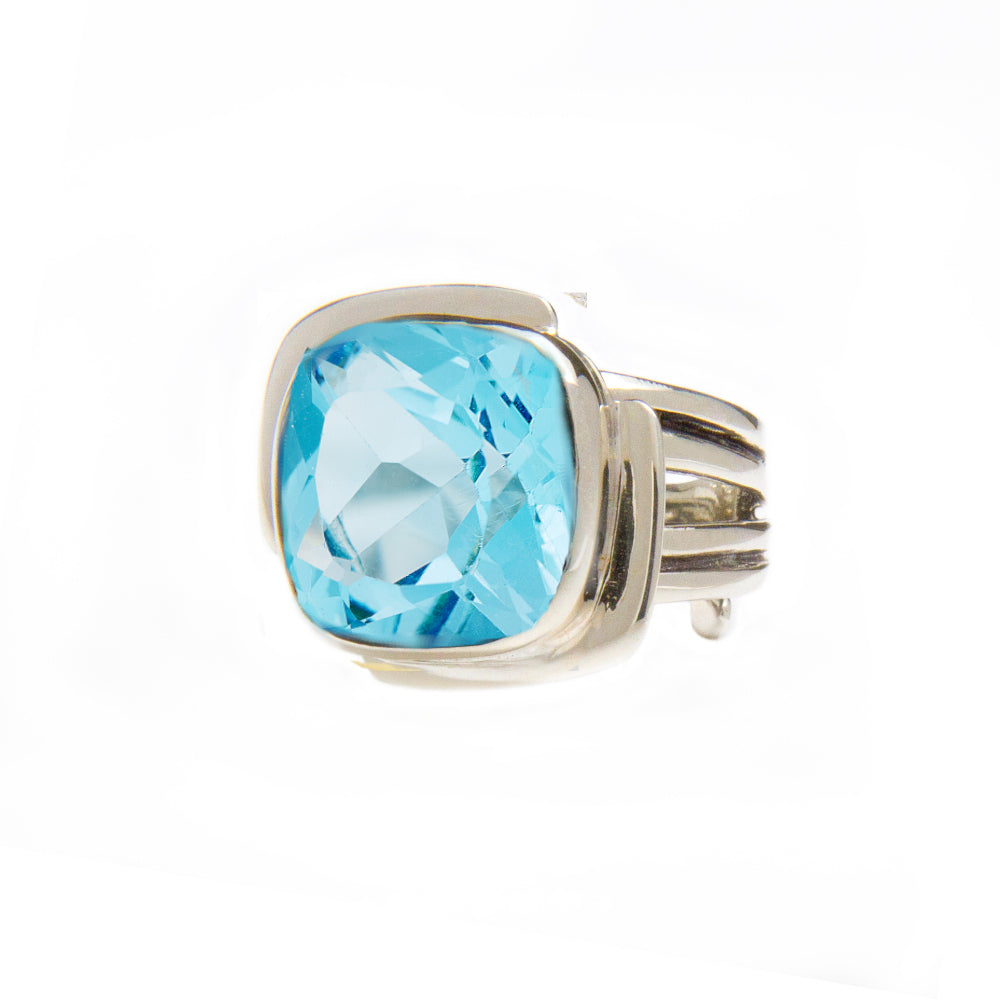 A Gallardo & Blaine Designs Art Deco Ring in Silver Gold & various gemstones featuring a large, square-cut blue gemstone in the center. The faceted gemstone adds to its sparkle. With a modern design and multiple thin bands converging at the back, this Art