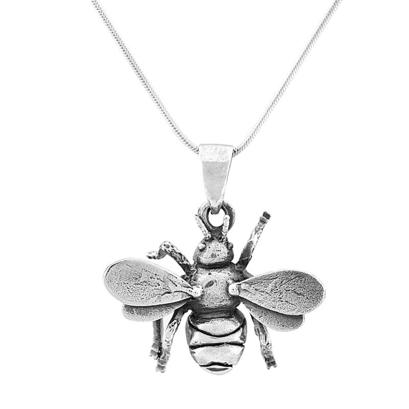 The Wildlife Pendant - Large Bee With Chain by Watermelon Tropical is a silver necklace with a detailed bee pendant featuring textured wings and body, suspended from a thin chain.