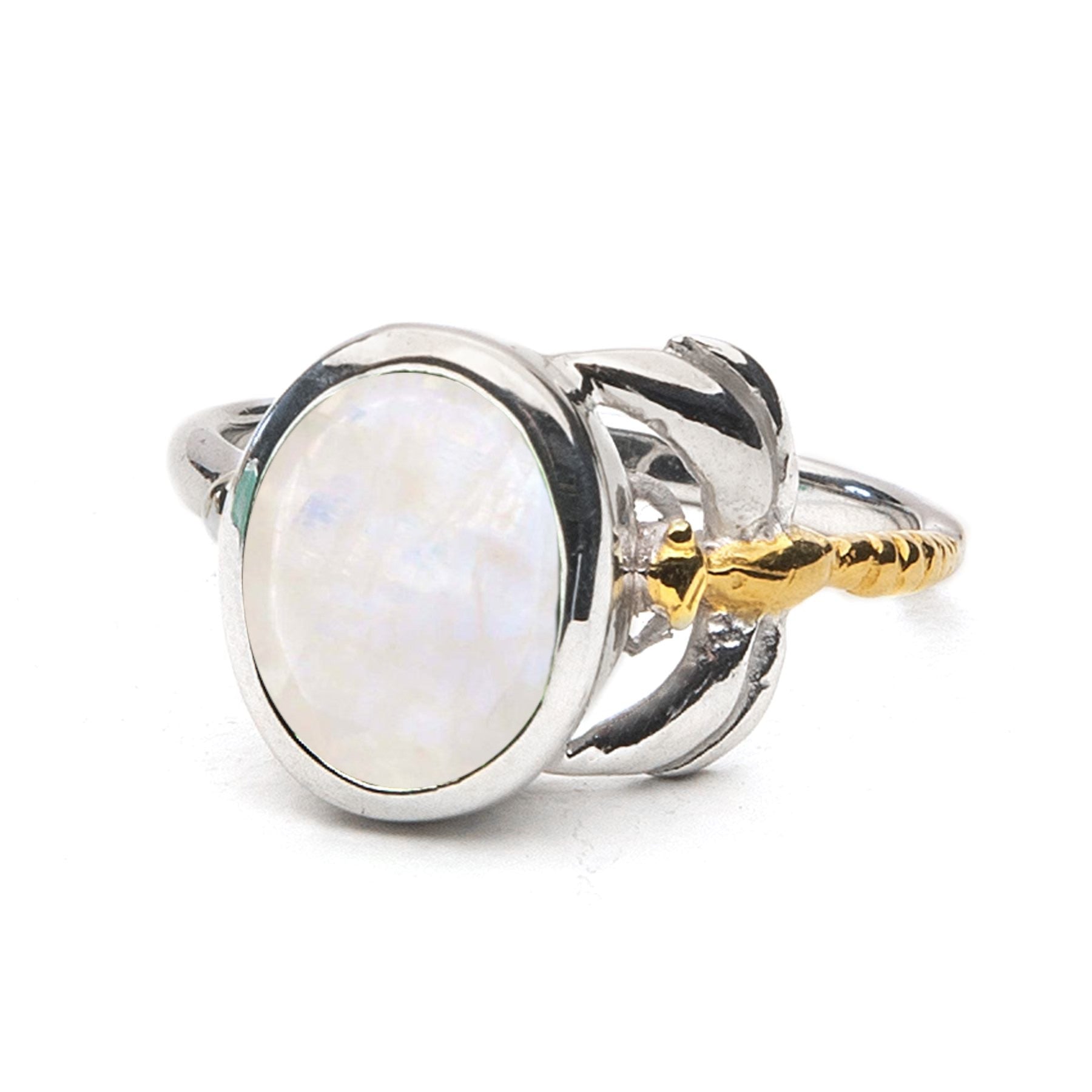 A close-up of the Daydream Ring in various gemstones by Gallardo & Blaine Designs featuring a polished oval gemstone set in a silver band with intricate gold accents. This timeless piece has a pearlescent sheen, reflecting light in various colors, and the