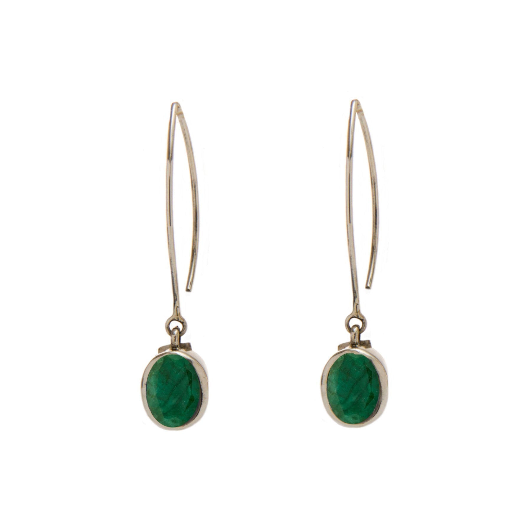 A pair of elegant Dew Drop Earrings in various gemstones by Gallardo & Blaine Designs featuring an elongated metal hook and an oval-shaped green gemstone set in a simple sterling silver frame. The earrings have a minimalist design, with the gemstone dangl