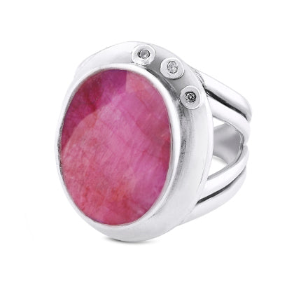 This statement **Eyetelia Ring in various gemstones** by **Gallardo & Blaine Designs** features a silver band with a large oval-shaped pink gemstone at its center. The smooth bezel setting is accented by small round diamonds on one side, and its adjustabl
