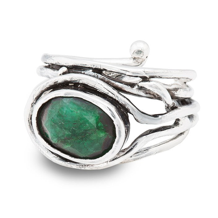 A Gallardo & Blaine Designs Fossil Ring in silver & various gemstones featuring an intricately designed, multi-band structure holding a large, oval-cut green gemstone at its center. The adjustable ring has a sculptural appearance with organic, flowing lin