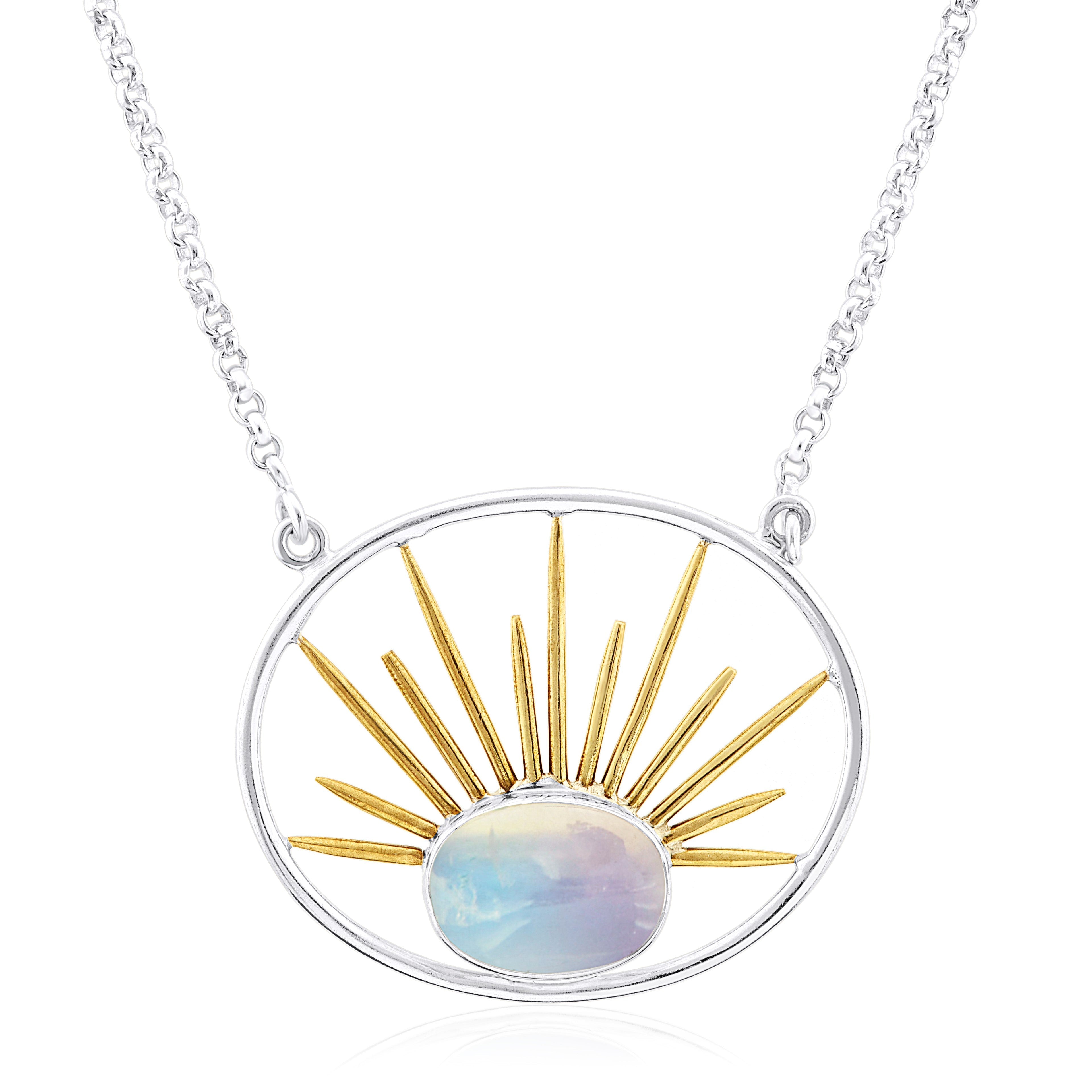 A silver necklace with a gold vermeil chain features an oval stone pendant. The pendant boasts a design of a sun with golden rays emanating from a central white opalescent stone, mimicking the look of a sunrise. This is the Goddess Necklace Large in Vario