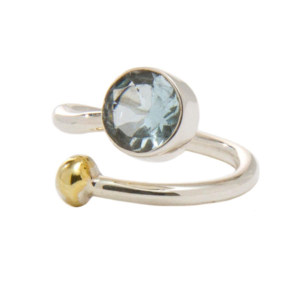 An elegant adjustable Honeysuckle Ring in Silver Gold & gemstones featuring a large, round, blue gemstone on one end and a small gold ball on the other, set in a silver band—perfect for those who appreciate silver and gold jewelry. This exquisite piece is