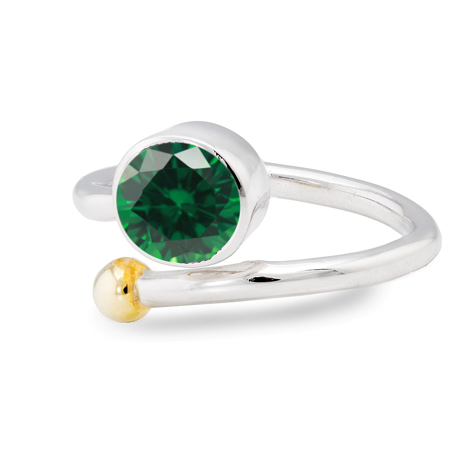 A silver and gold jewelry piece, the Honeysuckle Ring in Silver Gold & gemstones by Gallardo & Blaine Designs features an elegant adjustable gemstone ring design. It showcases a large round green gemstone on one end and a small gold bead on the other, hig