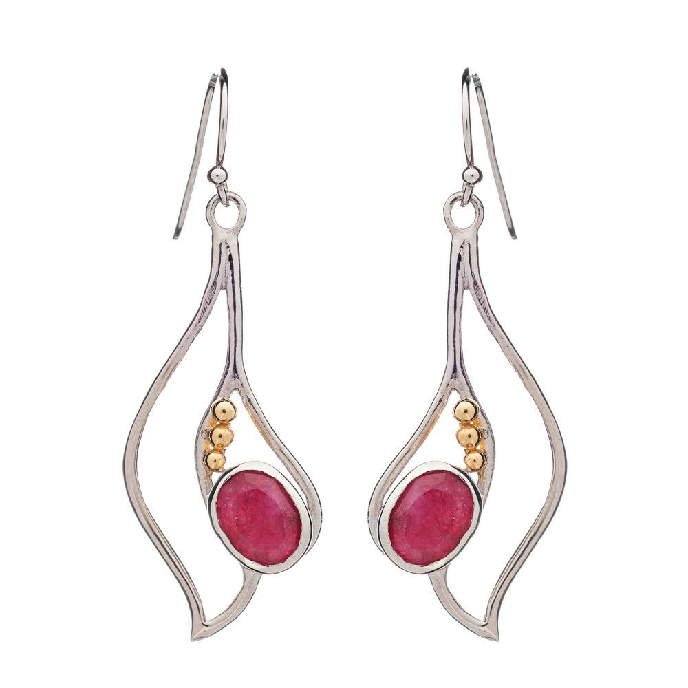 Introducing the Iris Earrings in various gemstones by Gallardo & Blaine Designs: elegant dangle earrings showcasing silver frames with fluid, wavy designs. Each earring is adorned with a pink oval gemstone and three small gold-colored beads. These exquisi