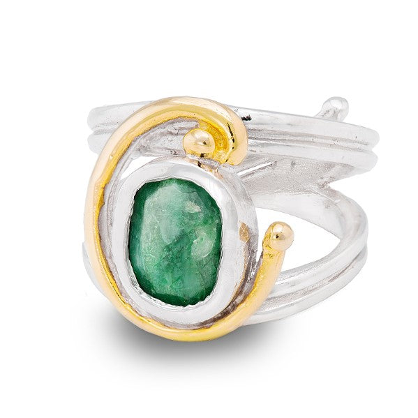A silver Art Nouveau ring featuring a large, rough-cut green gemstone encased in a gold bezel setting. The band of the ring is smooth and polished, with a slightly spiraled design that meets the gemstone setting, offering an adjustable design for perfect 