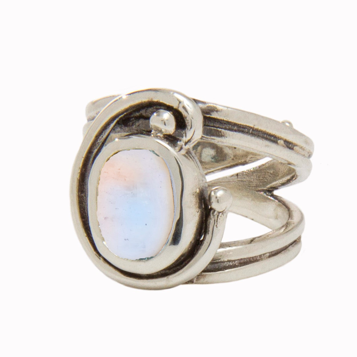 A silver Jasmine Ring in various gemstones by Gallardo & Blaine Designs featuring a large oval opal stone in the center. The band splits into three sections near the top, converging around the opal with a freeform design ending in small silver orbs. The s