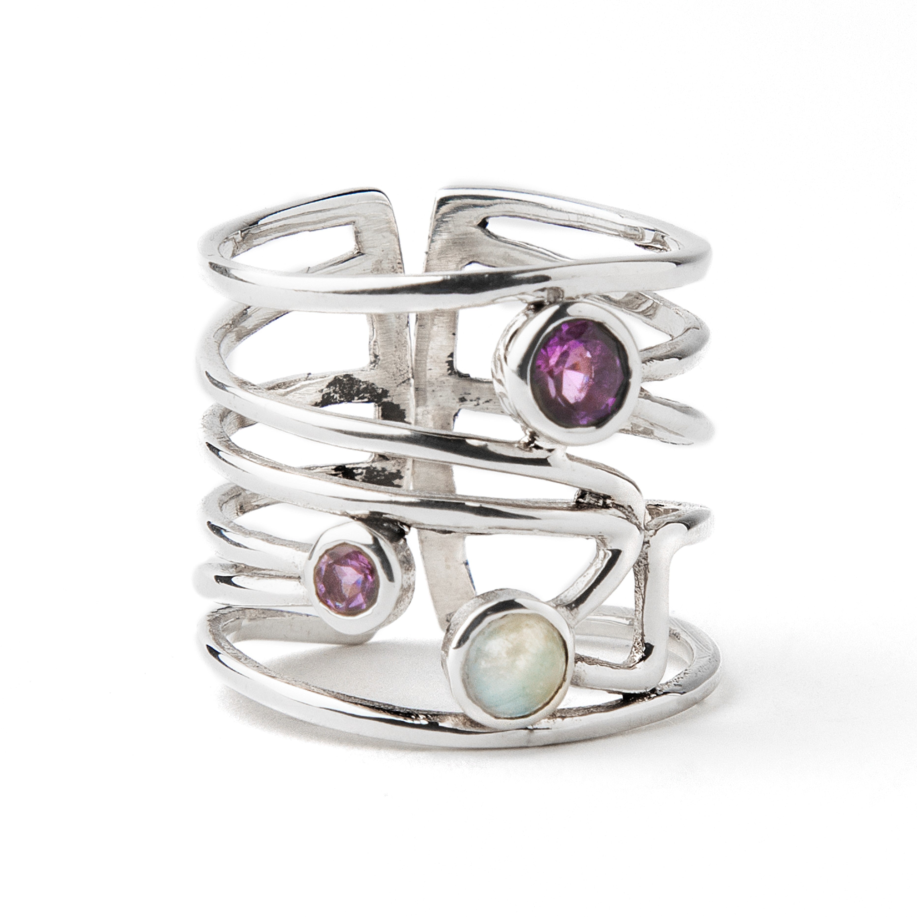 A Lattice Ring in various gemstones by Gallardo & Blaine Designs in silver featuring an open, multi-band design with three gemstones: a purple amethyst, a smaller purple stone, and a round opal, all set in a vertical arrangement. The ring's bands are inte