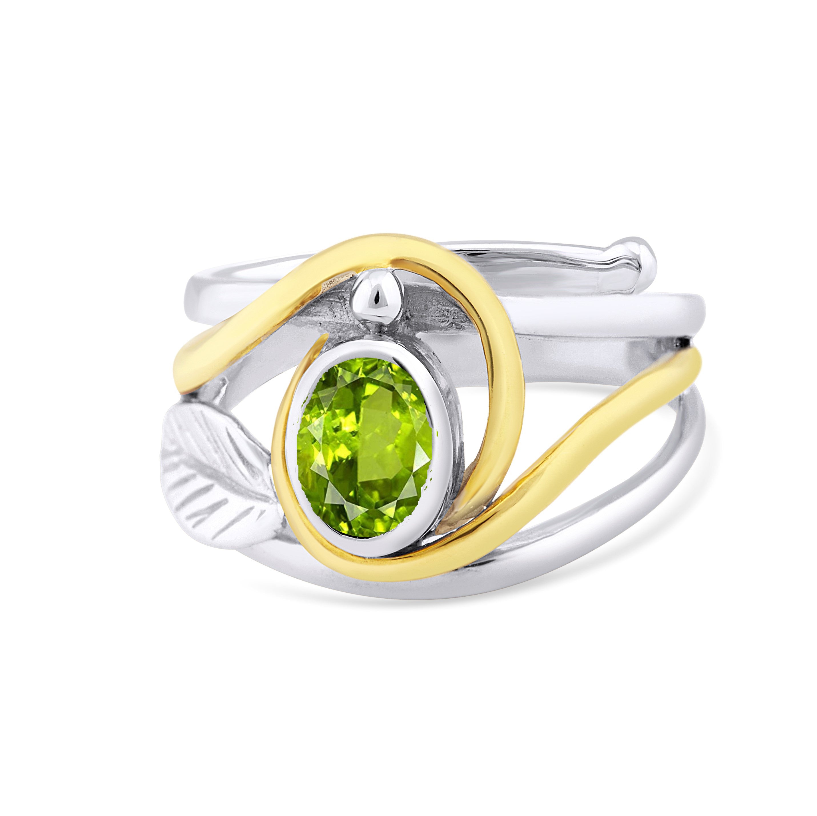 This elegant Leaf Ring in Silver Gold & various gemstones by Gallardo & Blaine Designs features a vivid green oval gemstone set in a two-tone band with a silver leaf accent on one side and a gold wave design wrapping around the stone. The band showcases a