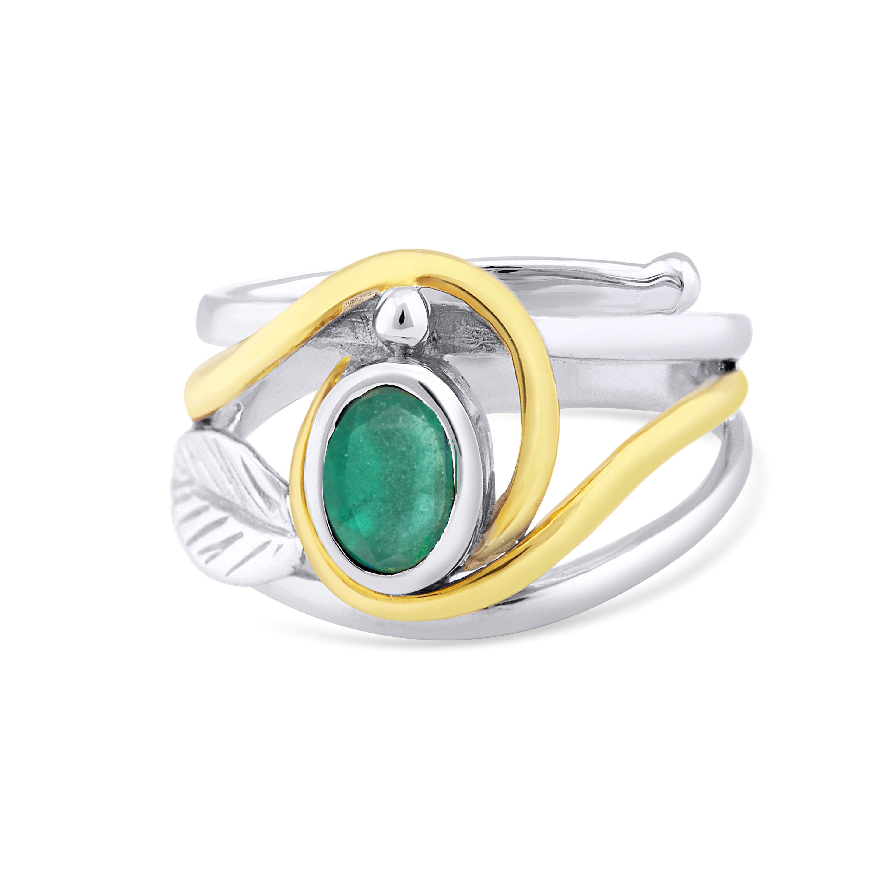 A Leaf Ring in Silver Gold & various gemstones with an intricate design featuring a central green oval stone and an overlapping gold-toned element. This elegant gemstone ring incorporates a silver leaf detail into the band, adding a natural touch to the s