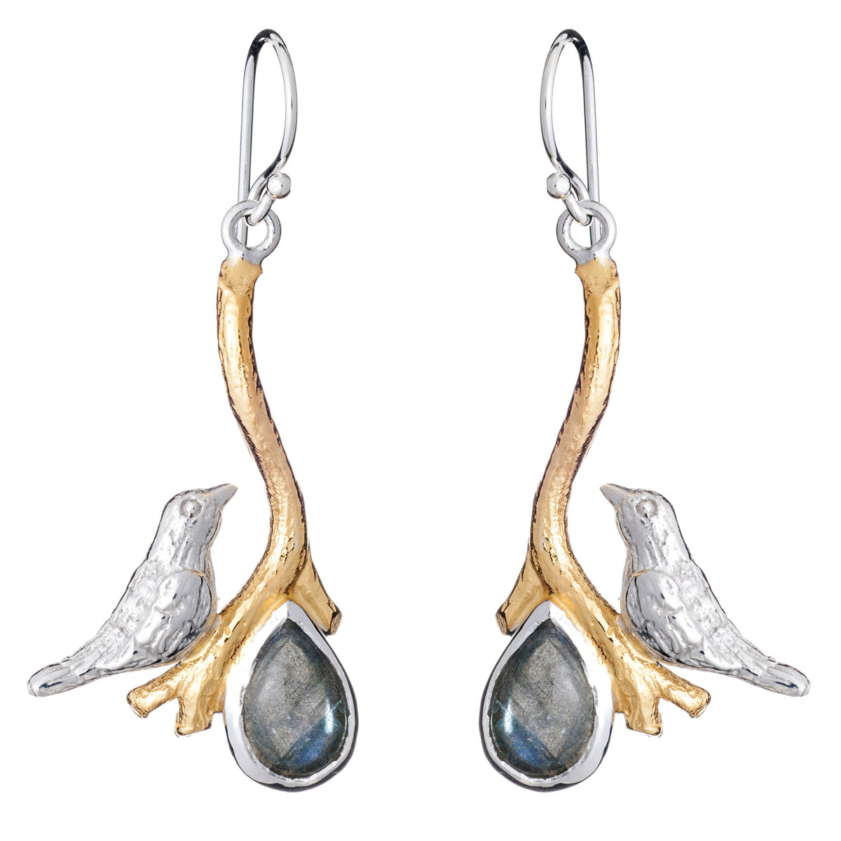 A pair of Lovebird Earrings in various gemstones featuring silver birds perched on golden branches. Below each bird hangs a teardrop-shaped pendant with a dark, reflective gemstone. These Gallardo & Blaine Designs dangle drop earrings have hook-style back
