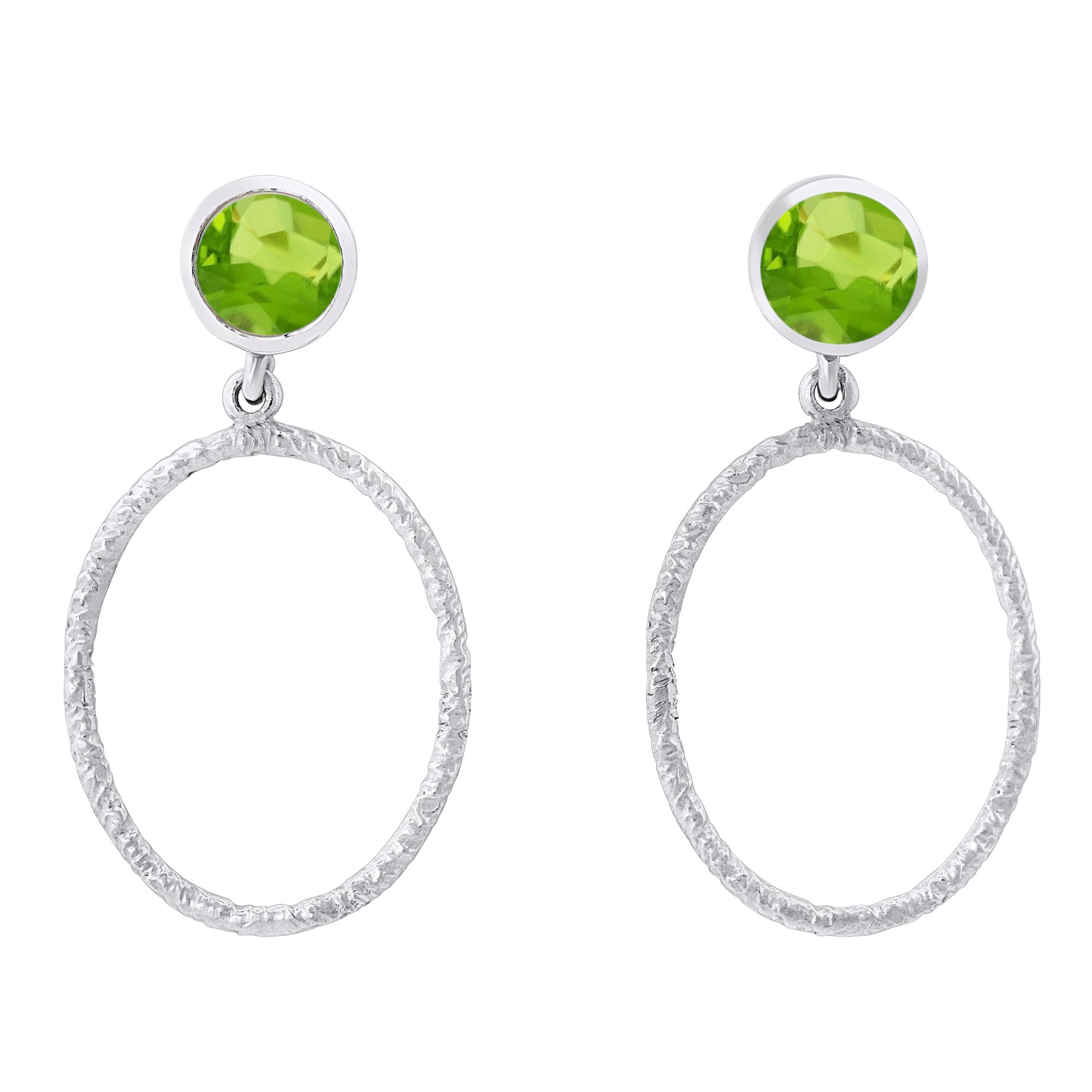 These Lunar Earrings in various gemstones by Gallardo & Blaine Designs feature a bright green gemstone at the top and a textured oval silver hoop dangling below. The design is elegant, with the green gemstone adding a pop of color to the minimalist silver