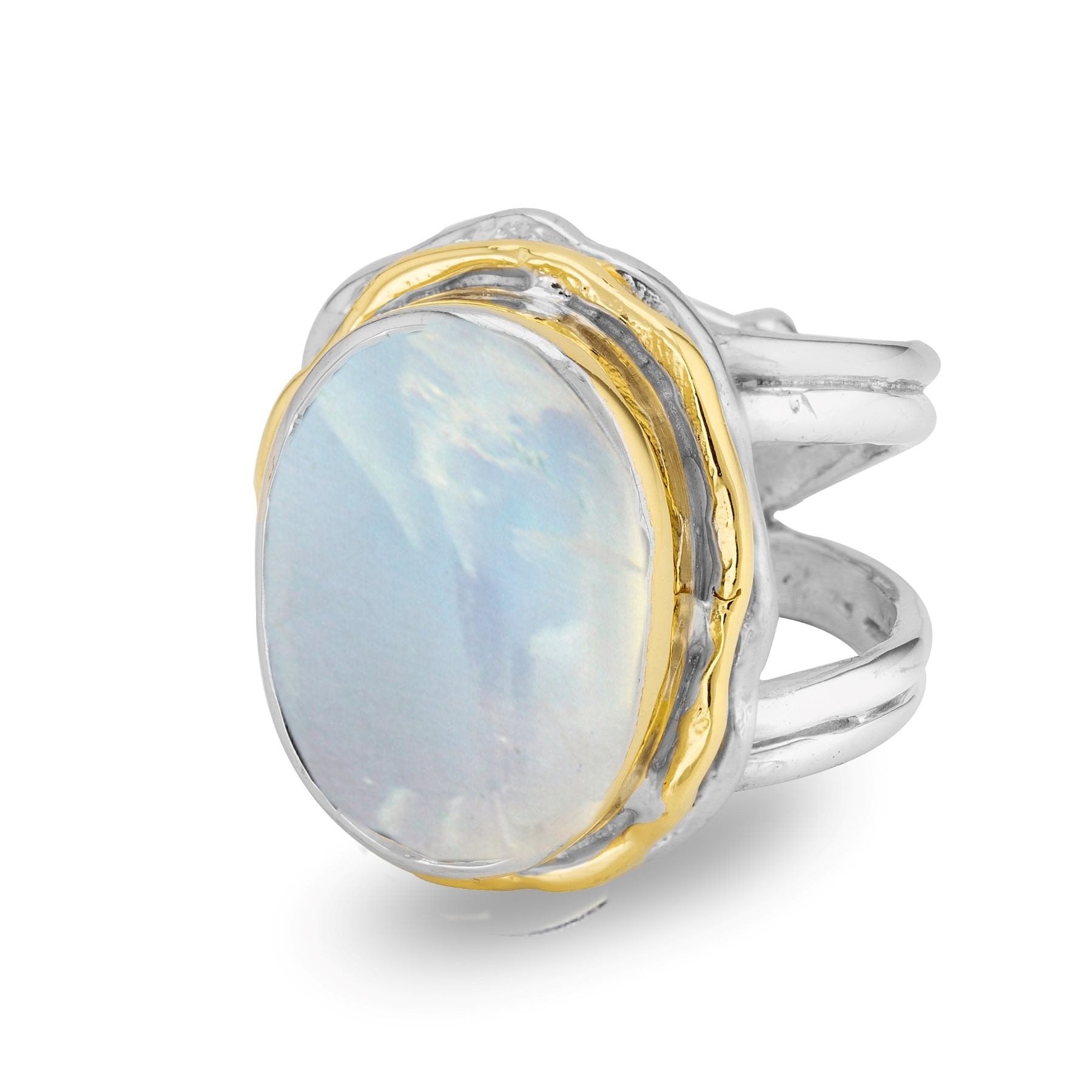 The Magnolia Ring in silver gold & various gemstones by Gallardo & Blaine Designs features a sterling silver band with a unique, intertwined design. At its center, a large, oval-shaped moonstone is set in a gold bezel, creating a stunning statement ring t