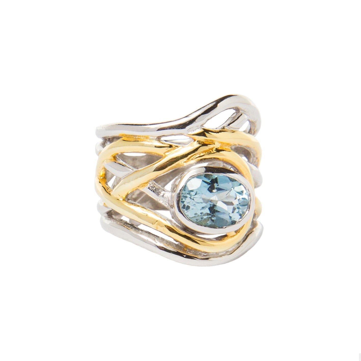 Introducing the Mayhem Ring in various gemstones by Gallardo & Blaine Designs: a silver and gold adjustable ring featuring an intricate, intertwined design with a central, round blue gemstone. The bands have an organic, wavy pattern, blending both metal c