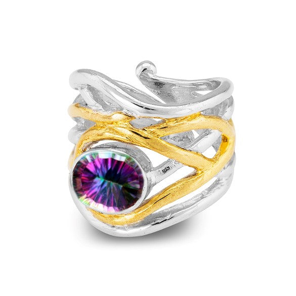 The Mayhem Ring in various gemstones by Gallardo & Blaine Designs is a silver and gold swirling band ring with a large, round, multicolored gemstone in the center. This chunky statement ring features an intricate, medieval-inspired design that intertwines