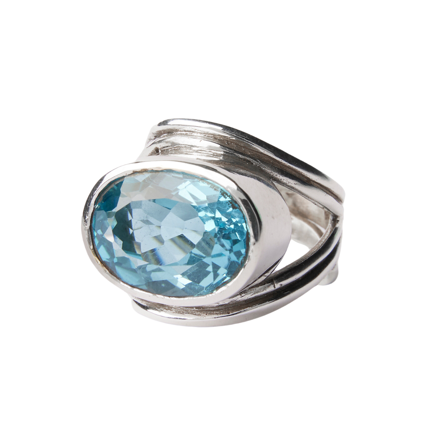 The Party Ring by Gallardo & Blaine Designs is a striking silver piece featuring an oval-shaped blue gemstone. Its simple, modern band highlights smooth lines for an elegant and polished look, perfect as a chunky statement accessory.