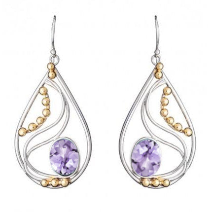 A pair of Phoenix Earrings in various gemstones by Gallardo & Blaine Designs featuring a silver frame with swirling designs. These elegant drop earrings have small gold beads along the curves and each showcases a large, faceted lavender gemstone at the bo