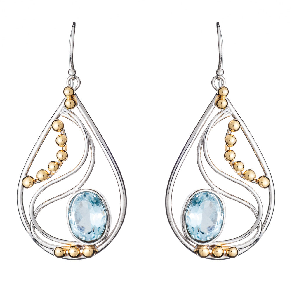 These Phoenix Earrings in various gemstones by Gallardo & Blaine Designs are a pair of elegant drop earrings featuring a combination of silver and gold elements. With a silver frame adorned with intricate swirls and small gold beads, each earring showcase