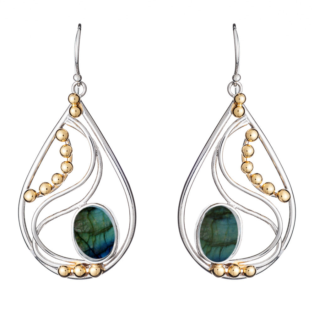 The Phoenix Earrings in various gemstones by Gallardo & Blaine Designs are an elegant drop design featuring a blend of silver and gold tones. Each earring showcases a greenish-blue oval stone at the center, framed by delicate gold beads arranged in gracef