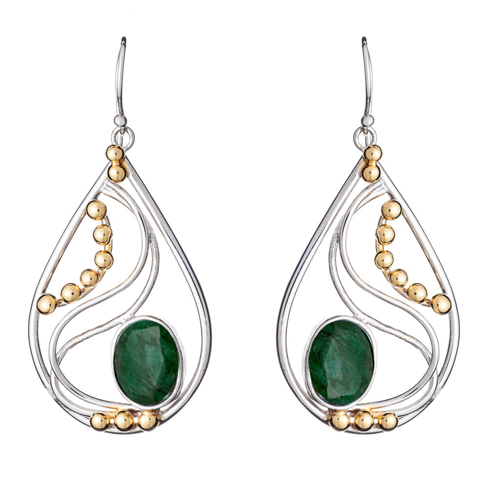 These elegant Phoenix Earrings in various gemstones from Gallardo & Blaine Designs are teardrop-shaped with a blend of silver and gold-colored elements. Each earring features a large green gemstone at the center, complemented by a wavy silver design and g