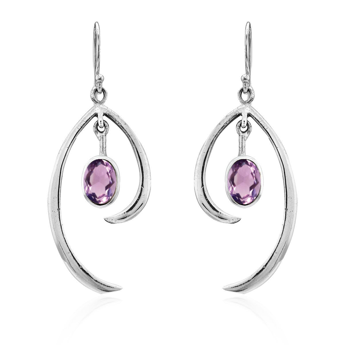 A pair of Gallardo & Blaine Designs Primrose Earrings in various gemstones featuring dangling oval-shaped purple gemstones. These sterling silver earrings include a sleek, curved metal element that elegantly cradles the gemstone, creating minimalist elega