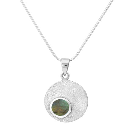 The Gallardo & Blaine Designs Selene Necklace Silver - Small in various gemstones showcases a silver pendant with a textured surface and a smaller circular, iridescent stone in hues of green and blue at the bottom left corner. It features a delicate, Ster