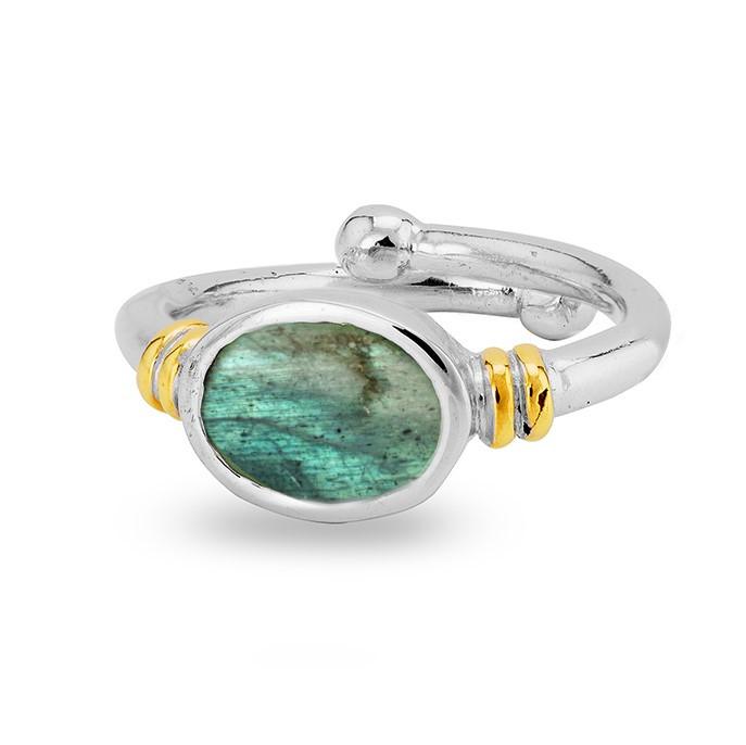 A Senna Ring in various gemstones by Gallardo & Blaine Designs featuring an oval-shaped green gemstone in the center. The band, with gold accents on either side of the stone and a small silver ball on one end, offers an adjustable appearance. This Art Nou