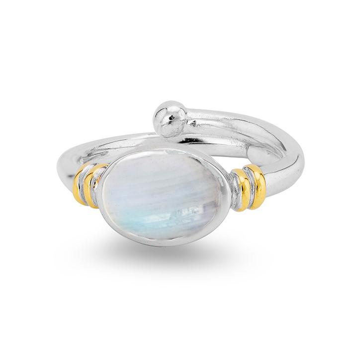 A Gallardo & Blaine Designs Senna Ring in various gemstones featuring an oval, translucent white centerpiece, adorned with small gold accents on either side of the stone setting. The band is smooth with a polished finish. The gemstone displays subtle irid