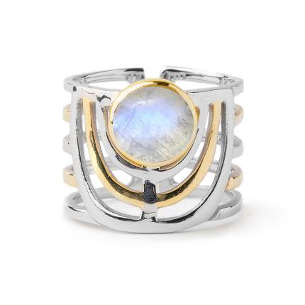 A wide band open ring featuring a central round iridescent gemstone. The Solar Ring in various gemstones by Gallardo & Blaine Designs has a mixed metal design with both silver and gold-toned elements, including geometric patterns and layered bands, giving