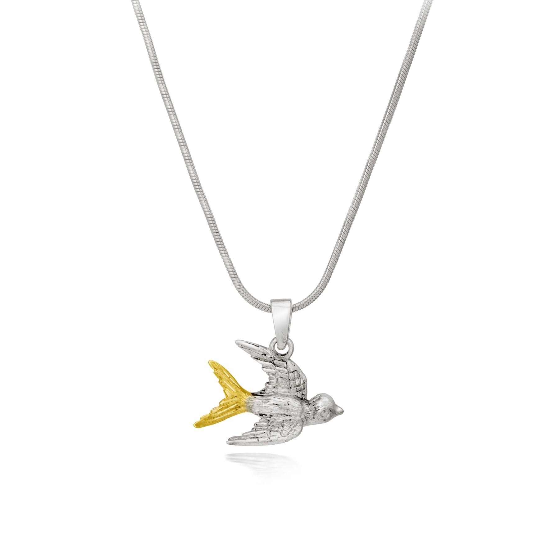 A sterling silver snake chain necklace featuring the Wildlife Pendant - Swallow With Chain by Gallardo & Blaine Designs. The bird has intricately detailed wings and body, while the 18ct gold plated tail feathers create a beautiful contrast against the sle