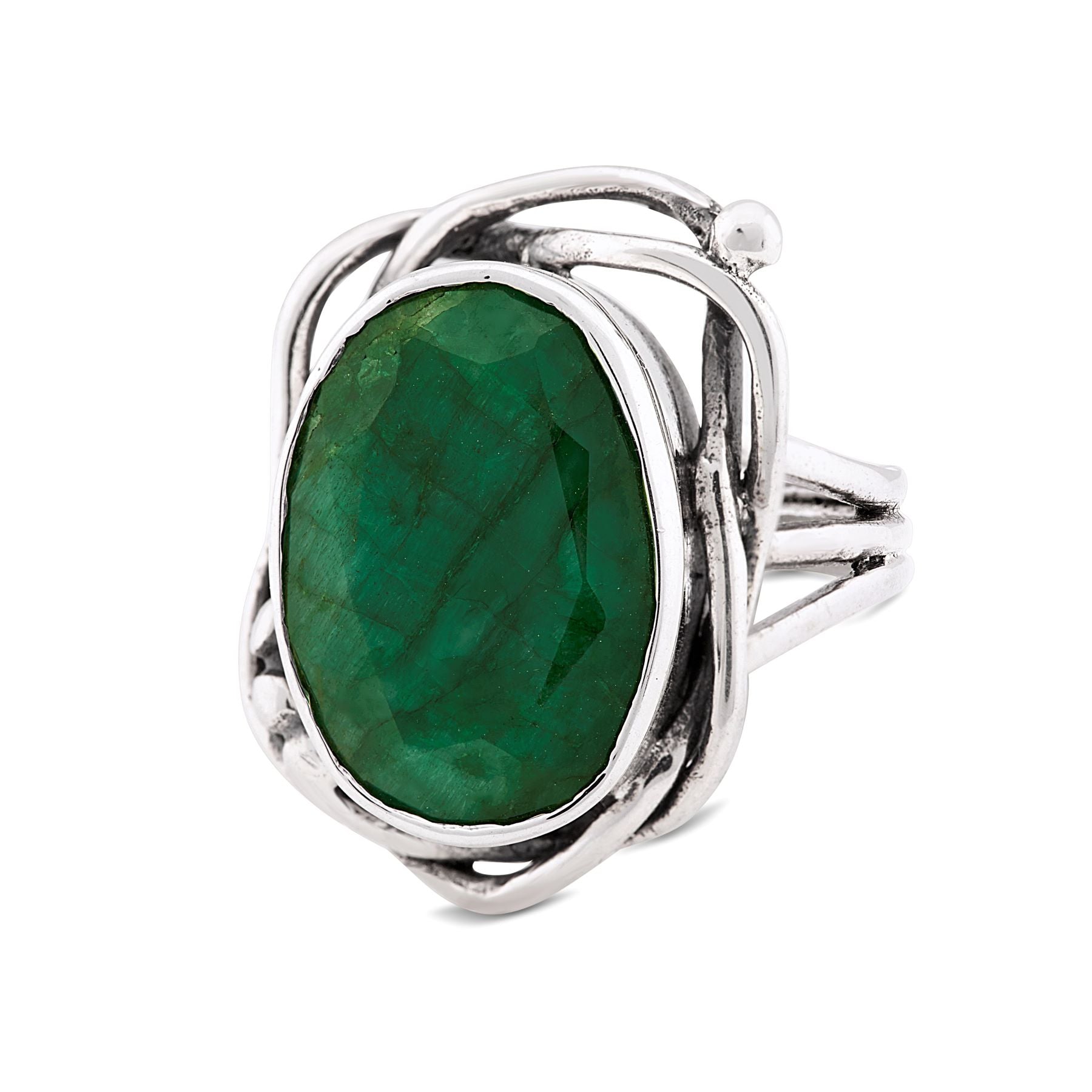 A captivating Gallardo & Blaine Designs Whirlpool Ring in various gemstones with an ornate band design features an oval-shaped, faceted green gemstone at its center. The gemstone is set in an intricate, looping silver setting that adds detail and elegance