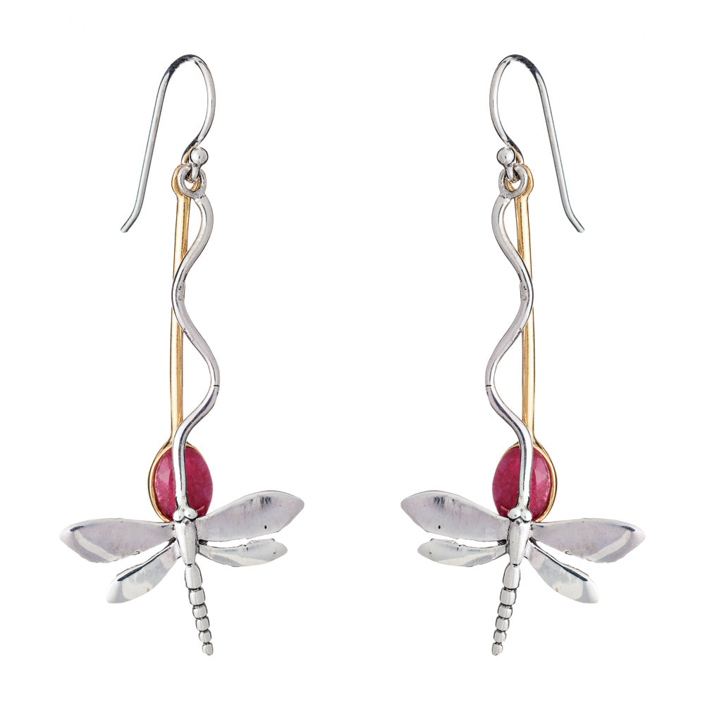 The Willow Earrings in Various Gemstones by Gallardo & Blaine Designs are a pair of dangle earrings designed to resemble silver dragonflies, featuring silver-toned bodies with gold-toned accents and red oval-shaped gemstones as the rear part of the bodies