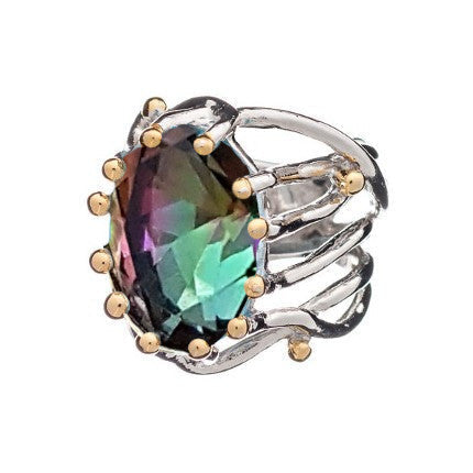 The Willow Ring in various gemstones is a silver piece with a large, oval-shaped, multicolored gemstone at its center. Reflecting hues of green, purple, and blue, this chunky statement gemstone ring from Gallardo & Blaine Designs also features an intricat
